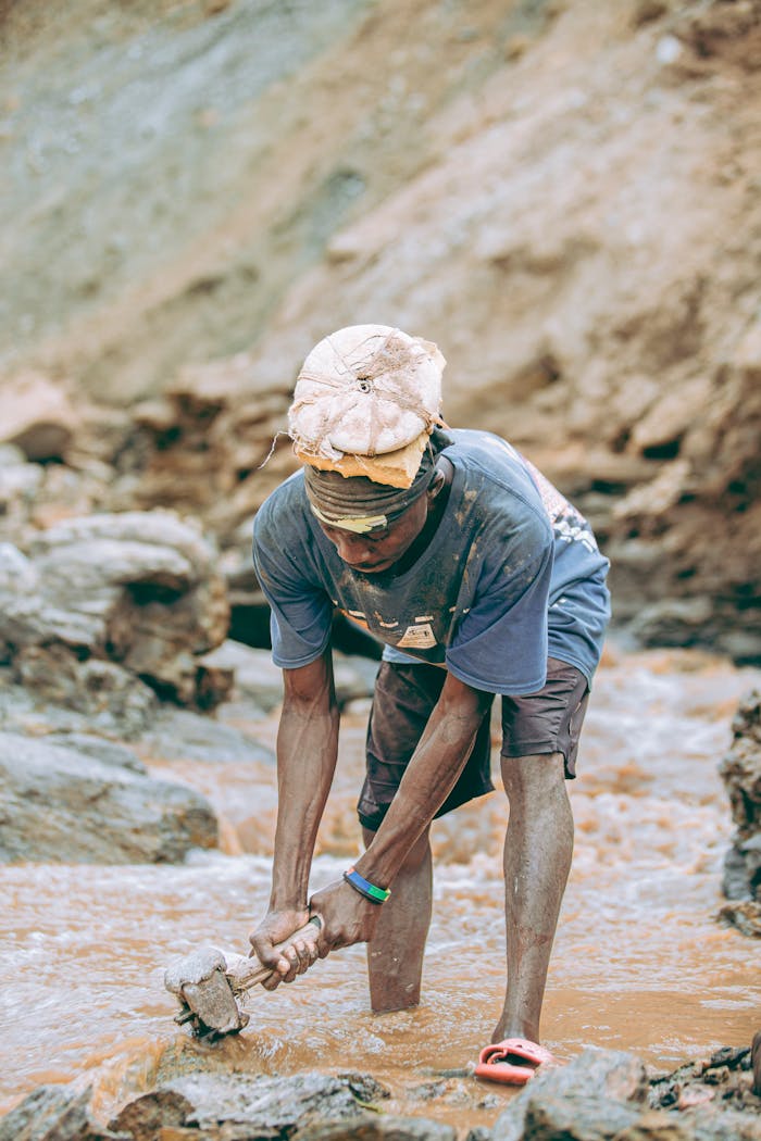 A dedicated miner in rugged terrain, exemplifying hard work outdoors.